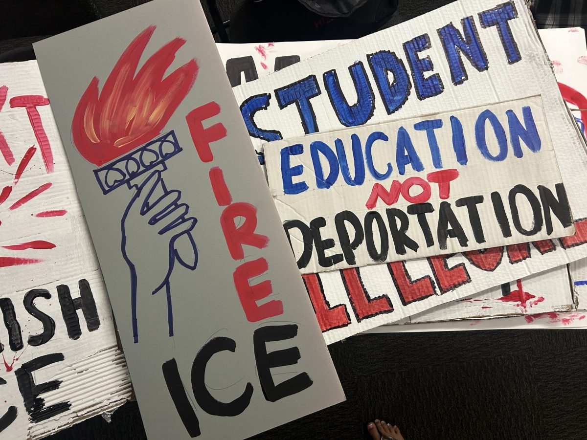 Students painting signs for “Students Rise Up” workshop on Monday, Feb. 23, in preparation for “ICE Out” protest on Wednesday.