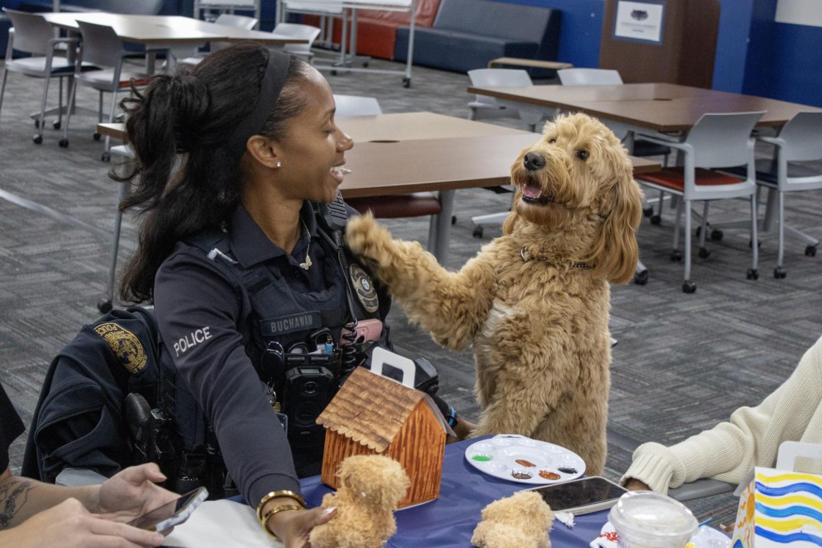  Photo of Nala and Officer Buchanan taken at Wimberly Paws and Paint event on March 18, 2026