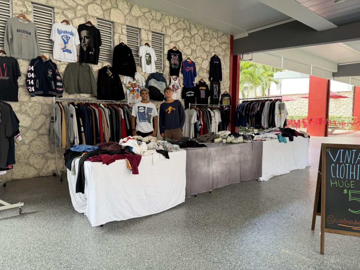 (From left to right) Jeremiah Almonte and Cassian Mitchell showcasing their “Wednesday Vintage” setup on the Breezeway of Florida Atlantic University's Boca Raton campus. 
