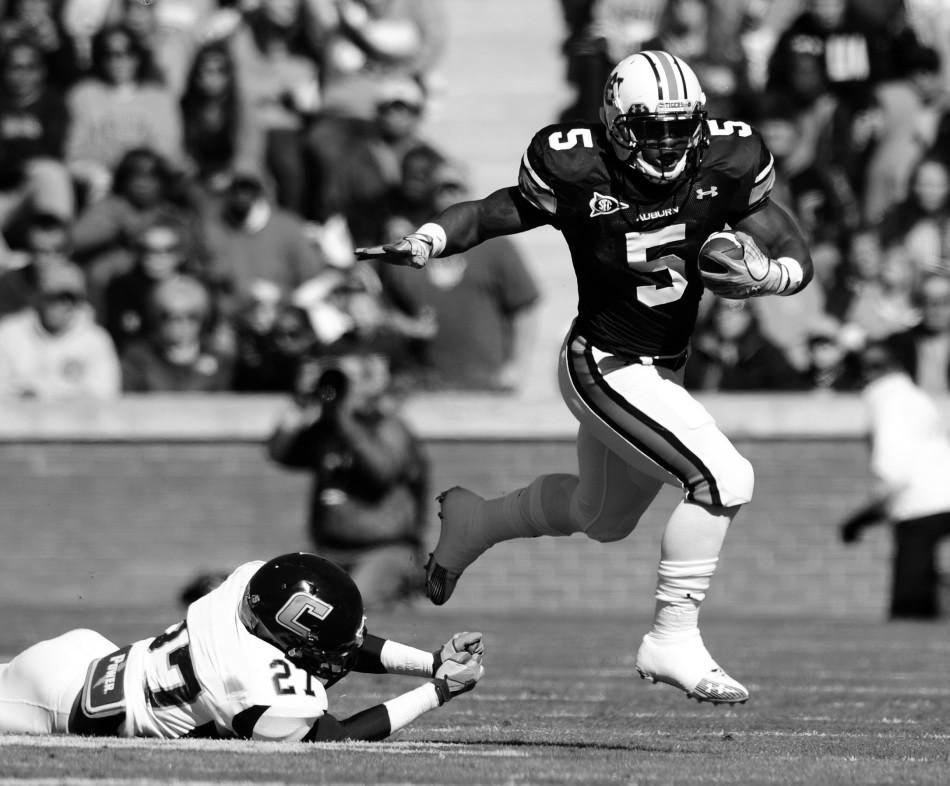 Sophomore running back Michael Dyer bolts past a fallen Tennessee Chattanooga defender in a game last November in Auburn. Photo by Tod Van Ernst