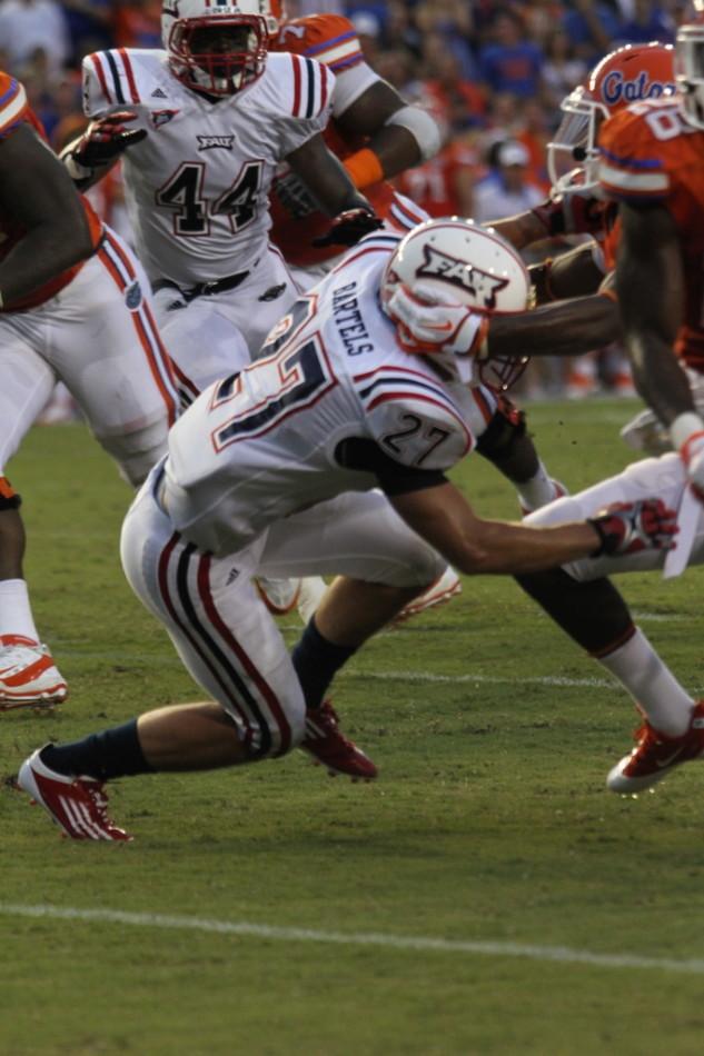 FAU+safety+Marcus+Bartels+gets+tossed+down+by+a+UF+defender+during+the+season+opening+game.+Photo+by+Lorenzo+Ponce+de+Leon.