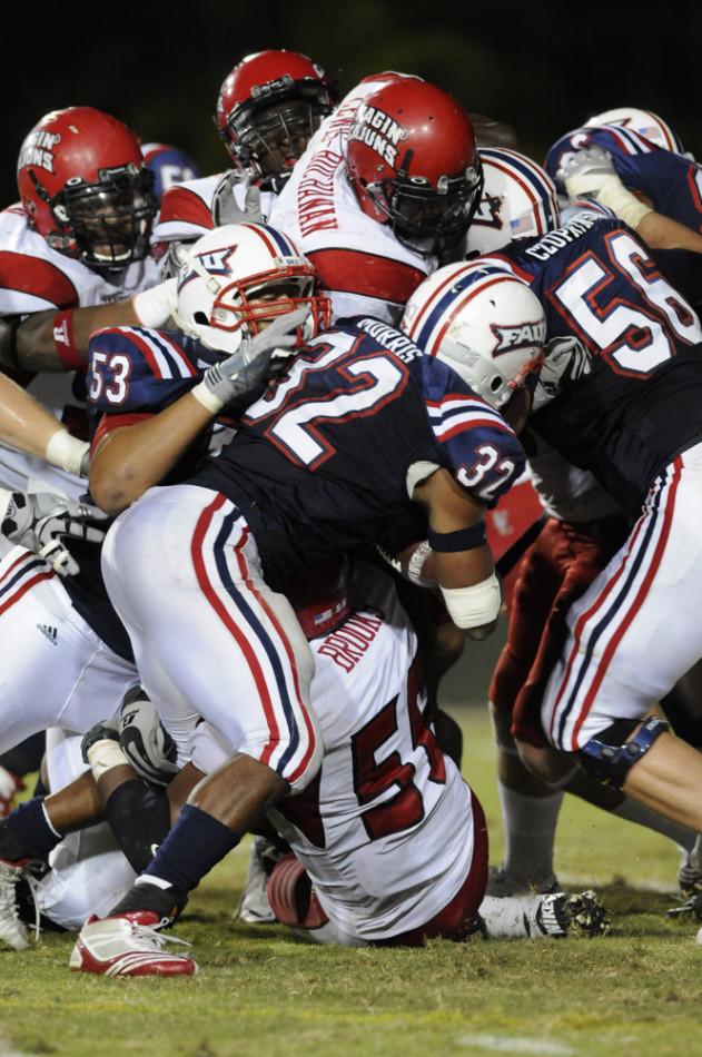 Running back Alfred Morris slams into a group of ULL defenders last year in a game FAU won 24-23.  Photo by Ralph Notaro.