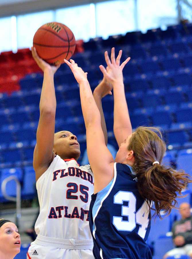 Owls center Chenise Miller shoots past Rhode Island forward Samantha Tabakman. Miller led the Owls with 16 points against the Rams Saturday, in the final game of the FAU Thanksgiving Tournament. 